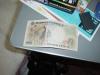 The back of the 2000-yen note features a scene from the Tale of Genji and a picture of its author, Murasaki Shikibu.