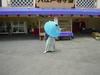 A showman spins a ball on top of a traditional umbrella.