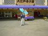A showman spins a ball on top of a traditional umbrella.