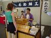 A vendor makes custom crafts for a couple of hundred-yen tickets.