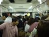 As we leave, the crowd on the subway tries to catch a glimpse of any remaining fireworks.