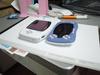 Notice that the SwanCrystal is slightly thinner than the Game Boy Advance, but the hump from the AA battery makes it sit tilted on the table.