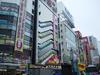 The view from the Akihabara train station exit.  Those tubes on the side of the building are windows positioned next to escalators in one of the department stores there.