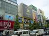 A view of a major street in Akihabara, featuring views of a Sega arcade and a large sign promoting the Xbox.