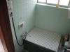 This is a traditional Japanese bathroom, made more compact than usual.  That white cover unrolls to reveal a traditional Japanese bath or ofuro, but that's only for soaking: I still had to wash myself using the shower as normal.